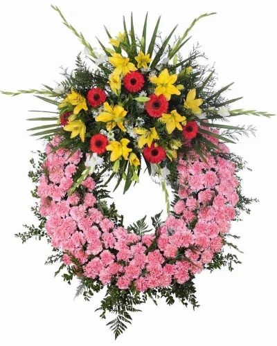 Corona fúnebre de claveles rosas con ramillete de lilium amarillo y gerberas rojas